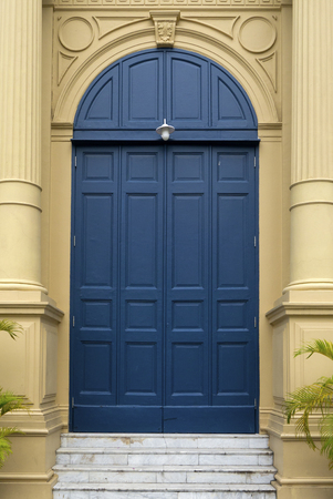blue entrance door in front of residential houseの写真素材