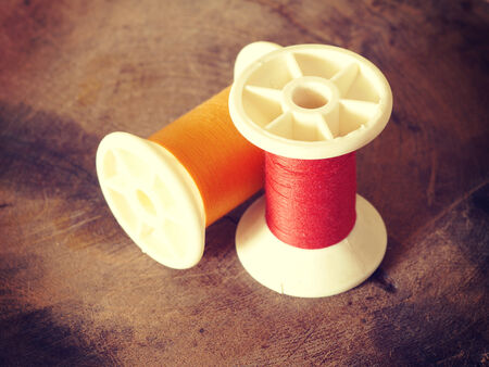 thread rolls on wood background old retro vintage style