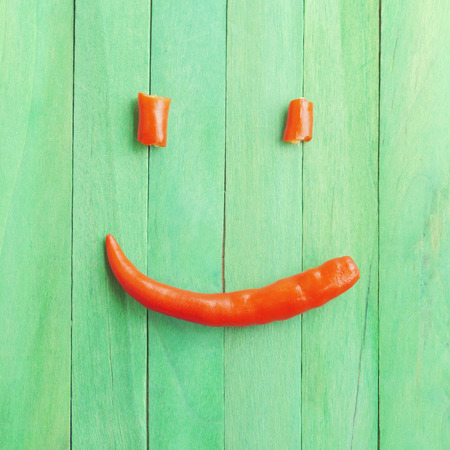 Red chili peppers in smile old retro vintage styleの写真素材