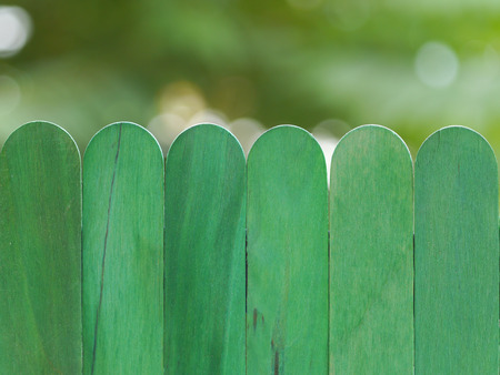 green wooden fence against bokeh  backgroundの写真素材
