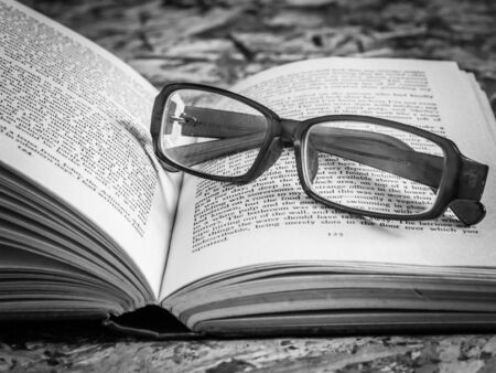 black and white glasses and bookの写真素材