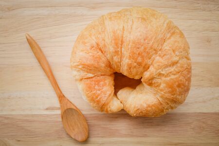 Fresh Croissants on wooden with retro filter effectの写真素材