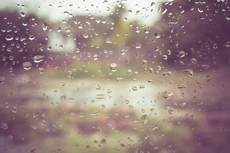 Drops of rain on glass with filter effect retro vintage styleの写真素材