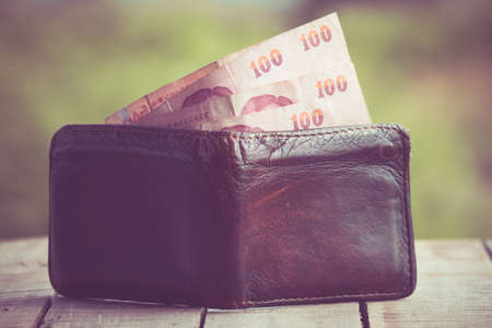 Money in leather wallet with filter effect retro vintage styleの写真素材