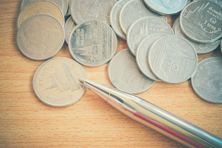 Pen and coins with filter effect retro vintage styleの写真素材