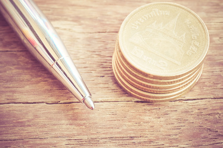 Pen and coins with filter effect retro vintage styleの写真素材