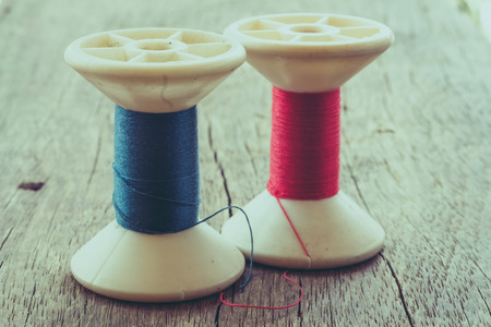 thread rolls on wood background with filter effect retro vintage styleの写真素材