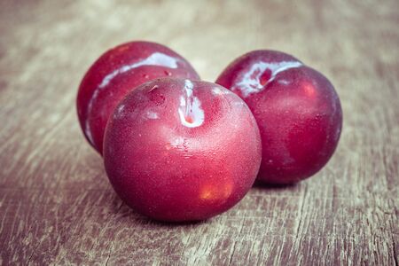 plums on wood background with filter effect retro vintage styleの写真素材