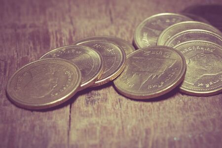 coins on wood with filter effect retro vintage styleの写真素材