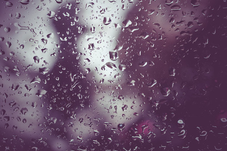 Drops of rain on glass with filter effect retro vintage styleの写真素材