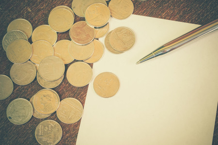 Pen and coins with filter effect retro vintage styleの写真素材