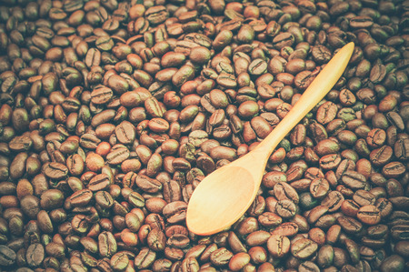 Coffee beans and wooden spoon with filter effect retro vintage styleの写真素材