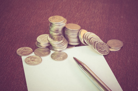 Pen and coins with filter effect retro vintage style