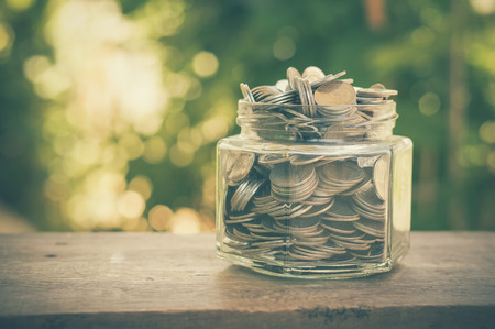 money in the glass with filter effect retro vintage styleの写真素材