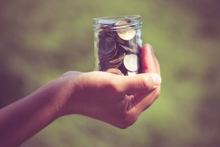 Hands holding money with filter effect retro vintage styleの写真素材