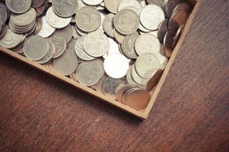 coins on wood with filter effect retro vintage styleの写真素材