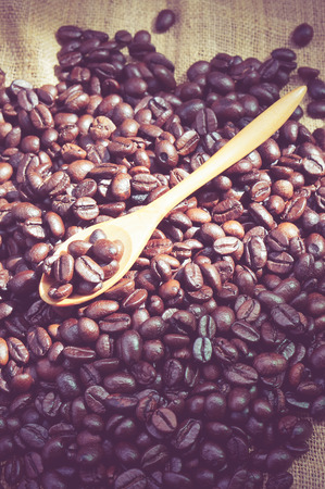 Coffee beans and wooden spoon with filter effect retro vintage styleの写真素材