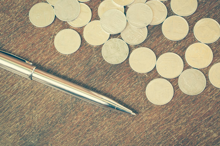 Pen and coins with filter effect retro vintage styleの写真素材