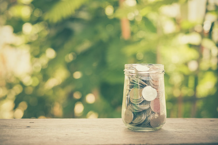 money in the glass with filter effect retro vintage styleの写真素材