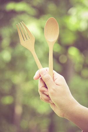 Woman hand and wooden spoon with filter effect retro vintage styleの写真素材