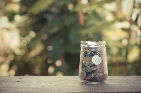 money in the glass with filter effect retro vintage styleの写真素材