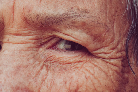 Senior woman's eye with filter effect retro vintage styleの写真素材