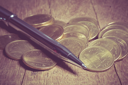 Pen and coins with filter effect retro vintage styleの写真素材