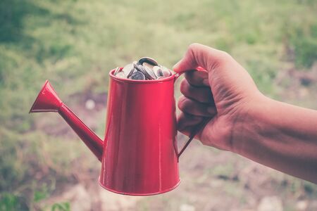 coin in red Watering-Can with filter effect retro vintage style