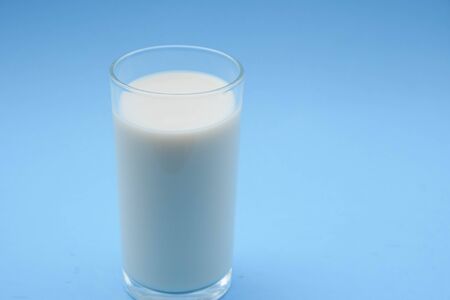 with milk on blue backgroundの写真素材