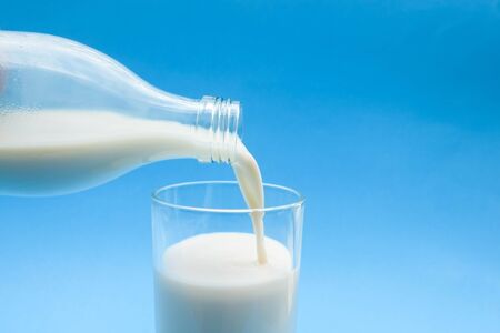 with milk on blue backgroundの写真素材