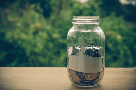 money in the glass with filter effect retro vintage styleの写真素材