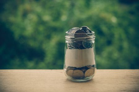 money in the glass with filter effect retro vintage styleの写真素材