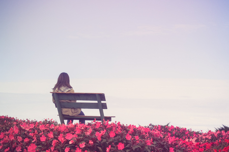 woman sitting in garden with filter effect retro vintage styleの写真素材