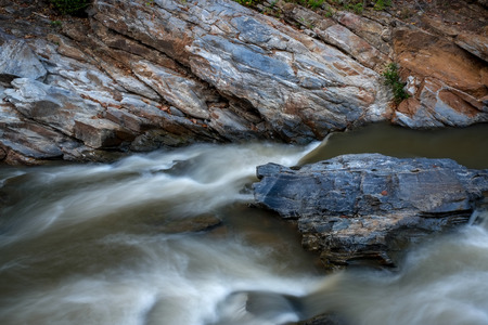 creek flowing over the rocksの写真素材
