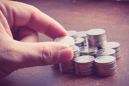 money concept coins baht thai and hand with filter effect retro vintage style