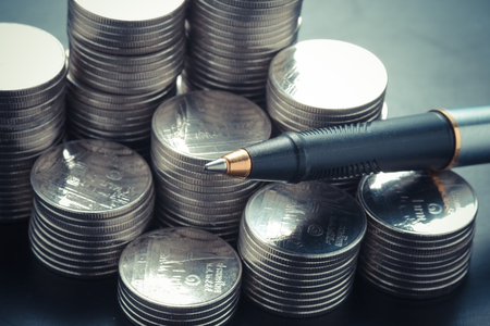money concept coins and pen with filter effect retro vintage styleの写真素材