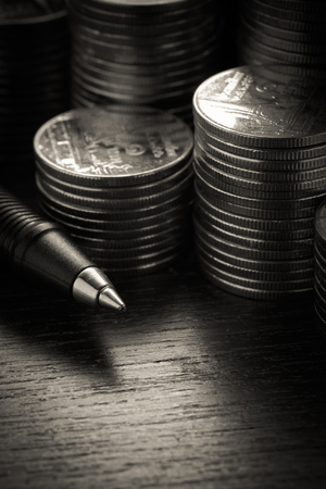 money concept coins and pen with filter effect retro vintage styleの写真素材