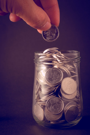 money concept coins baht thai and hand with filter effect retro vintage styleの写真素材