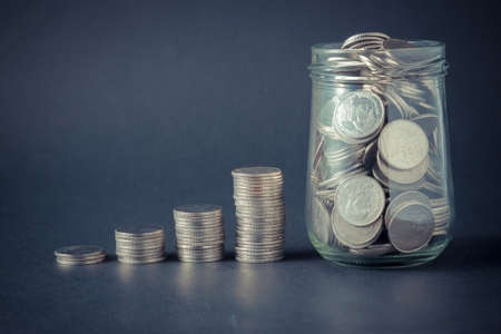 Money coin stack growing graph with filter effect retro vintage style