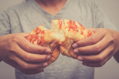 Hand holding bread  with hand with filter effect retro vintage styleの写真素材