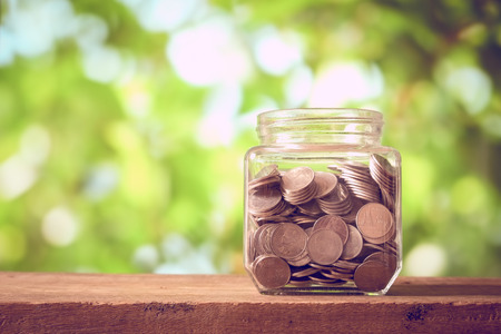 save money for investment concept money in the glass with filter effect retro vintage styl