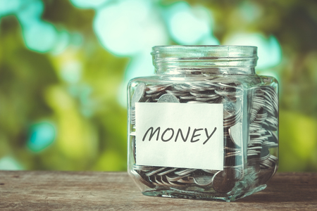 save money for investment concept money in the glass with filter effect retro vintage styleの写真素材