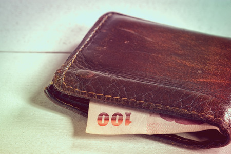 save money for investment concept money in leather wallet with filter effect retro vintage styleの写真素材