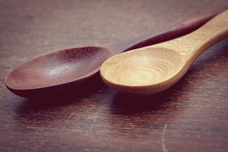 Wooden spoon on wood table with filter effect retro vintage styleの写真素材