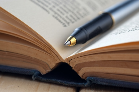 pen and book on wood backgroundの写真素材