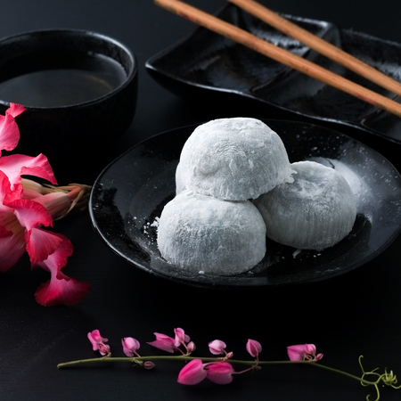 Japanese sweet black sesame daifuku on black wooden backgroundの写真素材