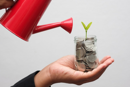 save money for investment concept hands holding moneyの写真素材