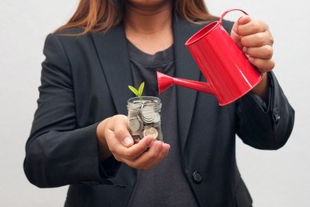 save money for investment concept hands holding moneyの写真素材