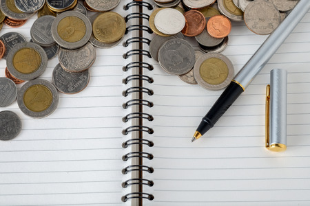 business finance. save money for investment concept coins and penの写真素材