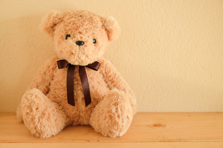 Teddy Bear toy alone on wooden tableの写真素材